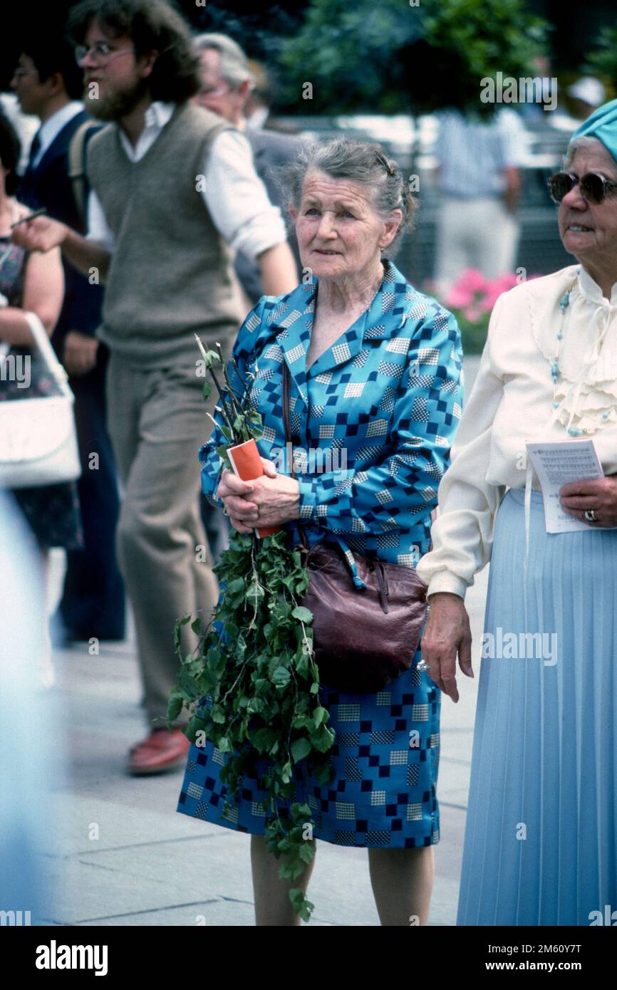 Elderly woman holding birch twig for Corpus Christi in 1982, Munich, Bavaria, Germany Stock Photo