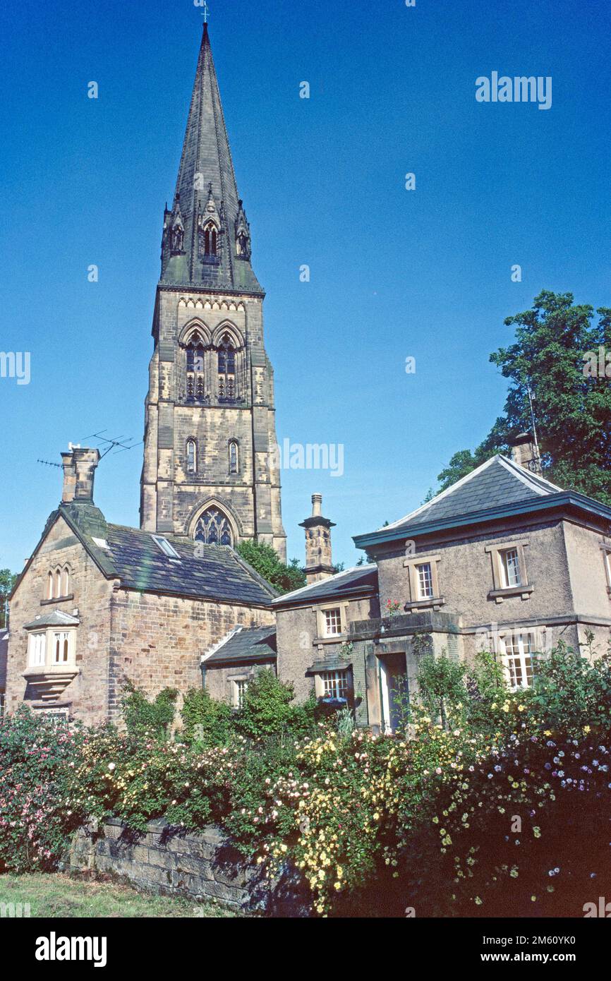 St Peter's Church spire behind houses in 1983, Edensor, Derbyshire Stock Photo