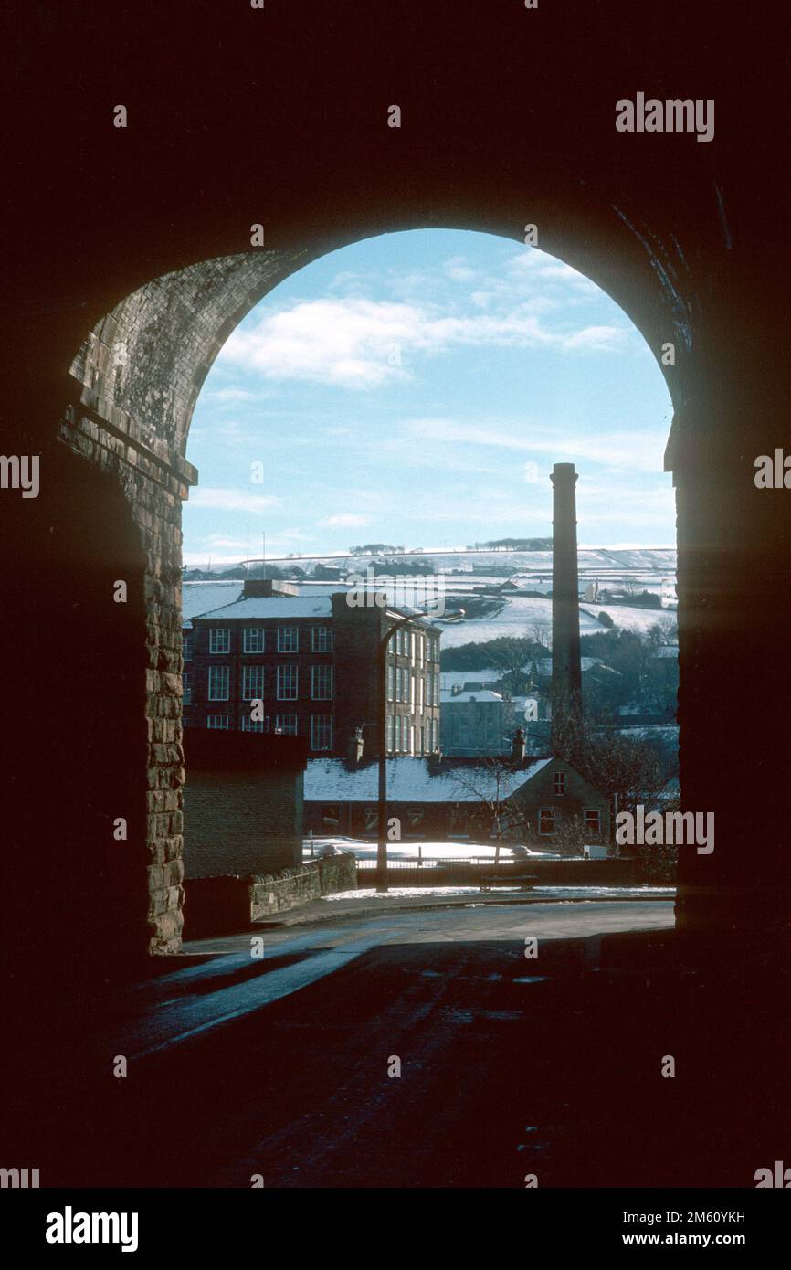 Old mill through the arches of Crimble railway viaduct in 1988, Slaithwaite, West Yorkshire Stock Photo