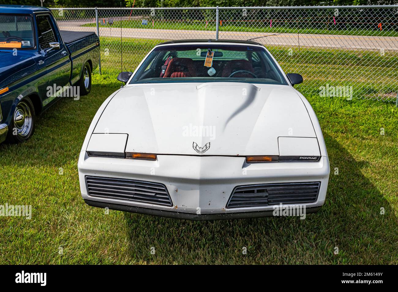 Iola, WI - July 07, 2022: High perspective front view of a 1984 Pontiac Firebird Trans Am at a local car show. Stock Photo