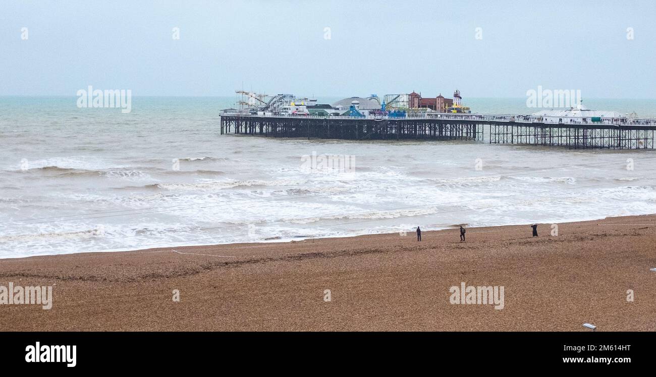 Brighton UK 1st January 2023 -  Members of the Royal Navy Bomb Disposal team working on the WW2 shell which was washed up on Brighton beach : Credit Simon Dack / Alamy Live News Stock Photo