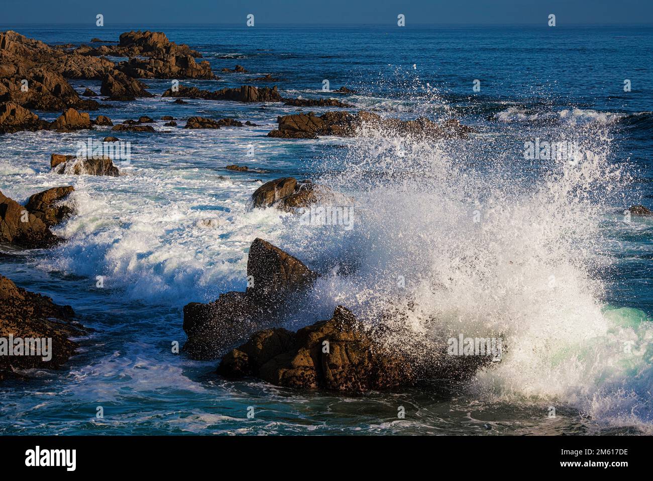 Waves crash along the rocky coast of Pacific Grove in Monterey, California Stock Photo