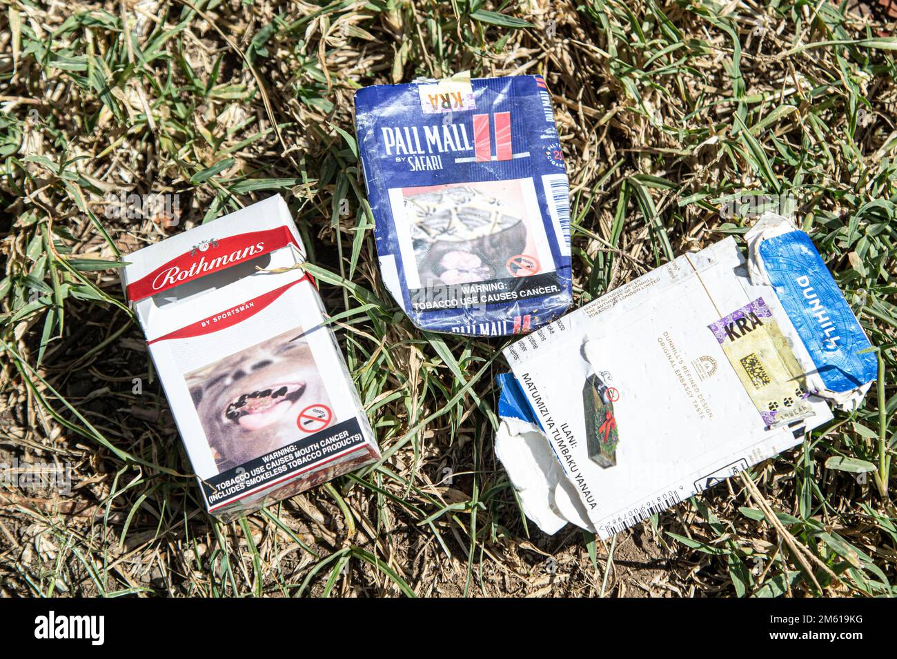 Empty packets of Rothmans, Pall Mall and Dunhill Cigarettes with a health warning written 'Tobacco Use causes cancer'  litters the environment near a popular entertainment spot in Nakuru. A study conducted by researchers at California’s UC Davis Comprehensive Cancer Center says nearly half of the deaths from 12 cancers are due to tobacco use. Stock Photo