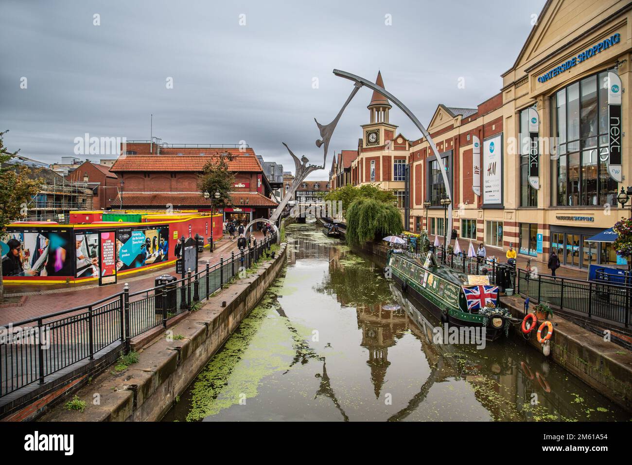 The Waterside shopping Centre, alongside the River Witham in Lincoln City Centre. The River is spanned by a striking sculpture entitled Empowerment. Stock Photo
