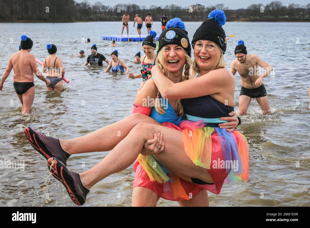 Haltern, Germany. 01st Jan, 2023. A group of ladies from SV Lembeck  swimming club in colourful outfits brave the water with a smile. Just over  380 registered swimmers, plus visitors, have fun