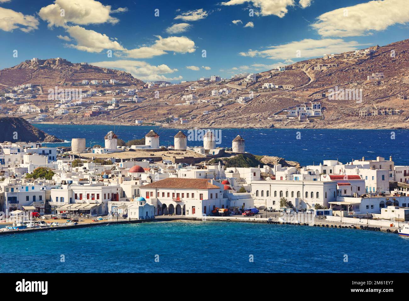 The famous windmills and the port of Mykonos island, Greece Stock Photo