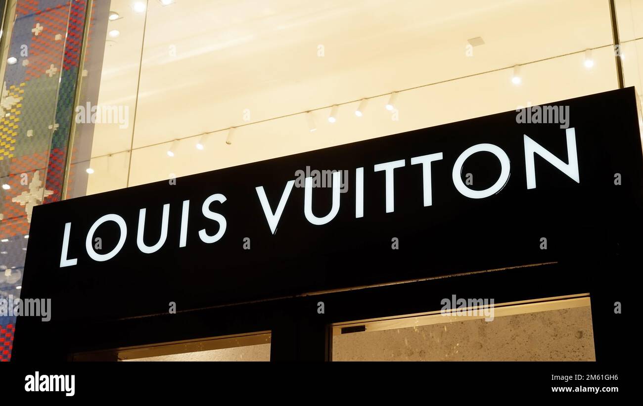 Louis Vuitton store in London at night - LONDON, UK - DECEMBER 20, 2022 Stock Photo