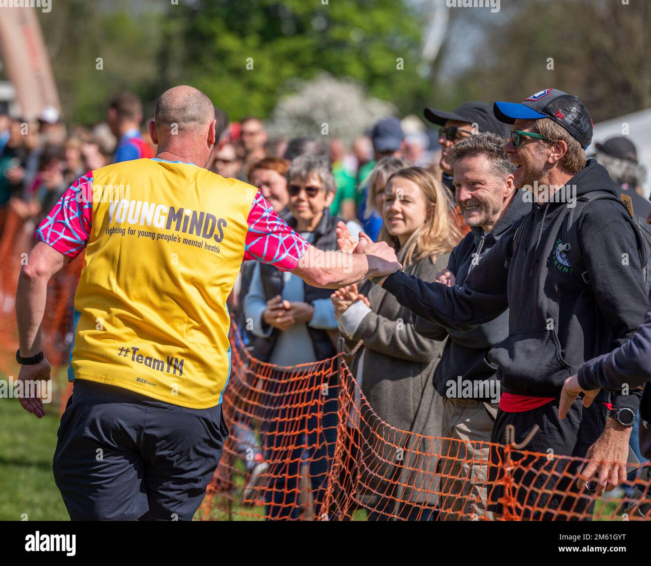 A Young Minds charity marathoner being praised by the watching crowd. Stock Photo