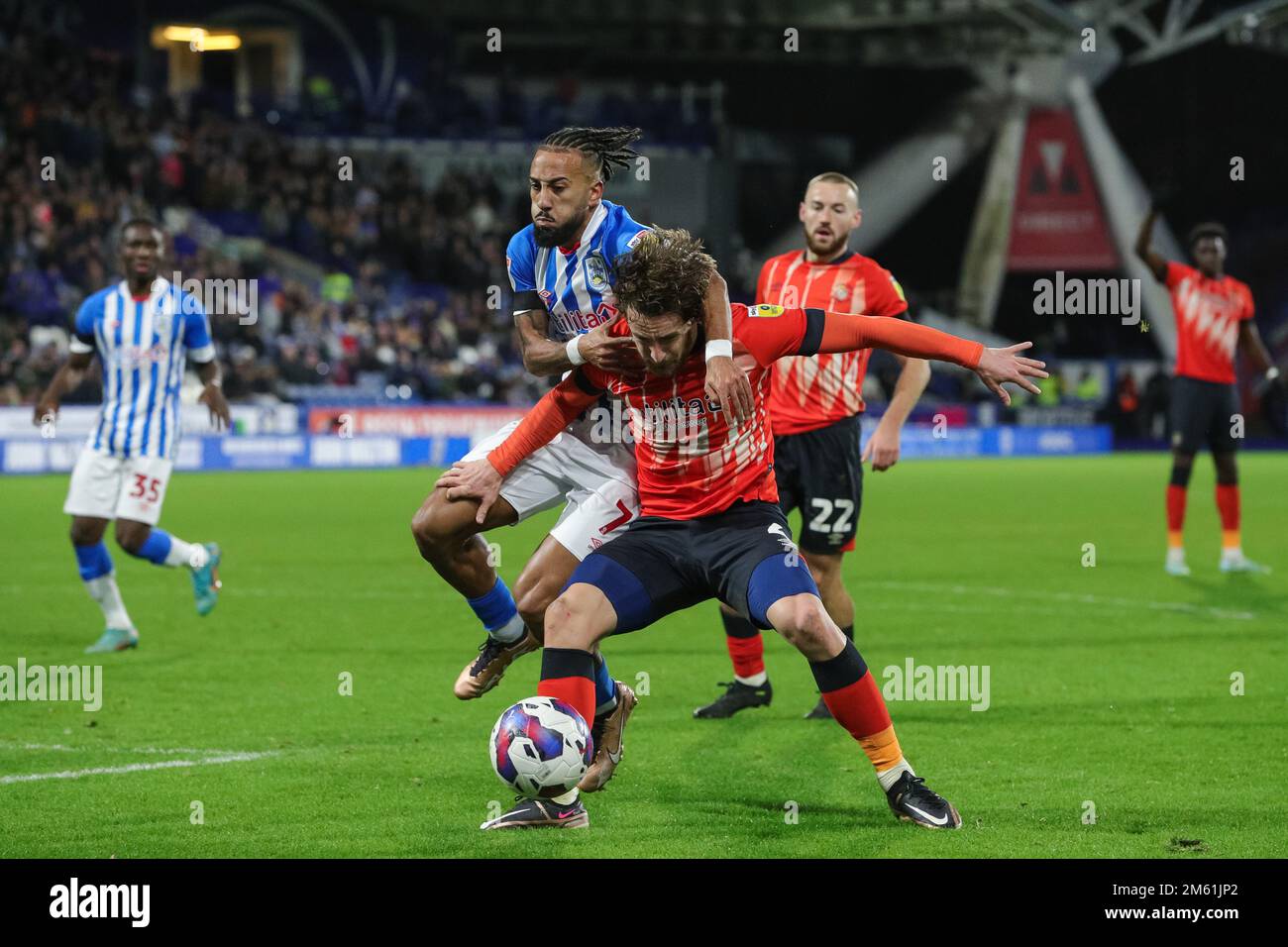 Sorba Thomas #7 of Huddersfield Town and Tom Lockyer #4 of Luton Town tussle for the ball during the Sky Bet Championship match Huddersfield Town vs Luton Town at John Smith's Stadium, Huddersfield, United Kingdom, 1st January 2023  (Photo by James Heaton/News Images) Stock Photo