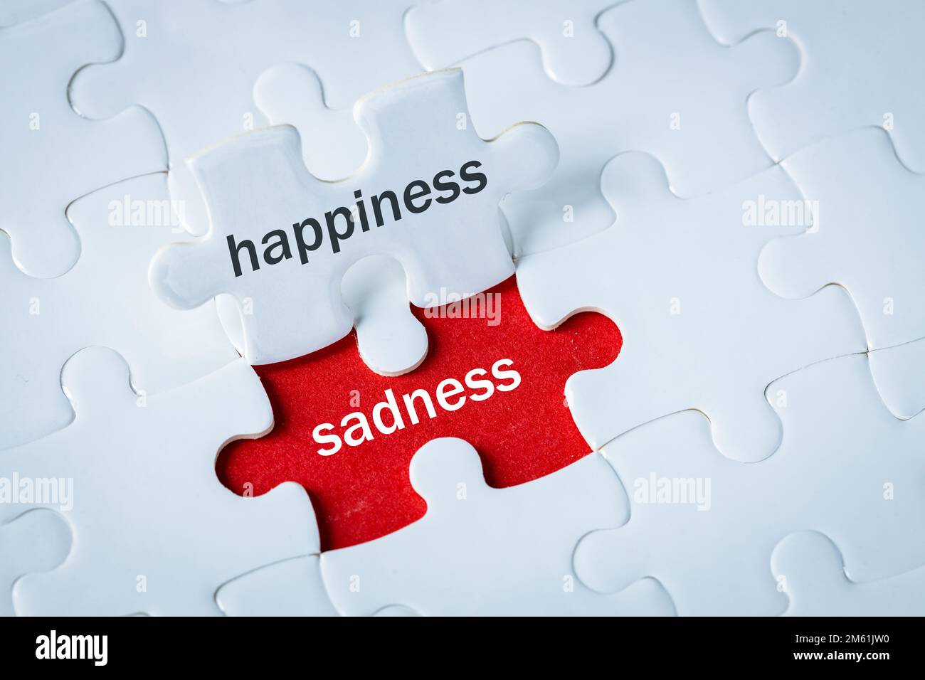 happiness and sadness, emotions joy and disappointment, Moods changing, Positive and negative, White Happy puzzle revealing red background with sadnes Stock Photo