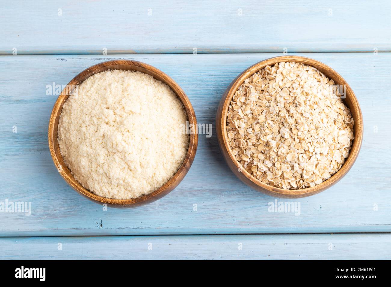Powdered milk and oatmeal baby food mix, infant formula on blue wooden background. Top view, flat lay, artificial feeding concept. Stock Photo