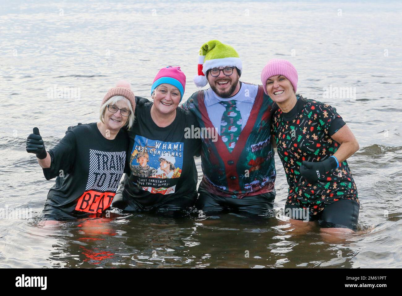 Irvine, UK. 1st Jan, 2023. Several hundred took part in the annual 'Polar Plunge', this year called 'Get Freezin' for a Reason' off Irvine beach, Ayrshire, Scotland, at the Firth of Clyde. The event, organised by Coastwatch Irvine, attracts several hundred participants and almost all do it to raise money for charities. Credit: Findlay/Alamy Live News Stock Photo