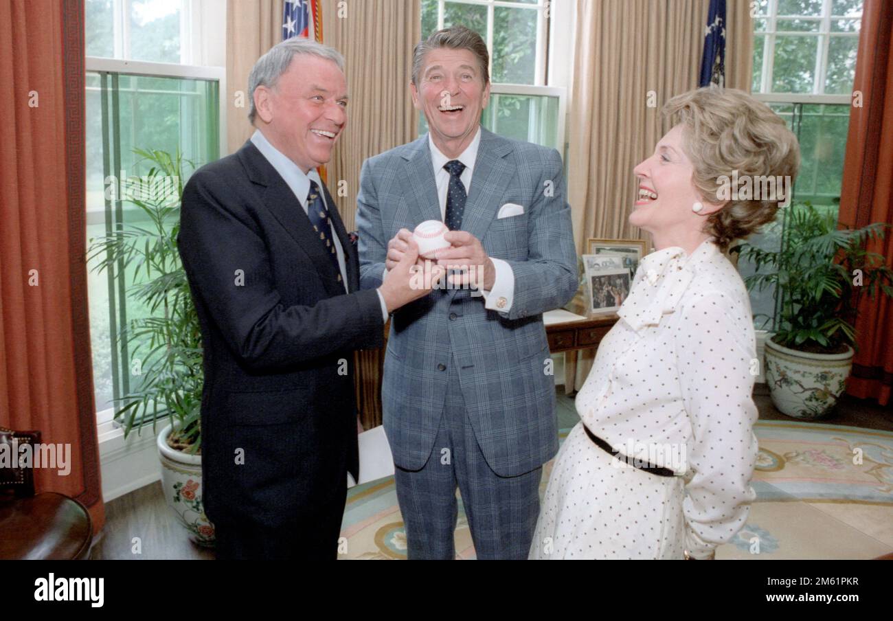 6/3/1981 President Reagan receiving a baseball on behalf of the Multiple Sclerosis Society in the Oval Office with Nancy Reagan and Frank Sinatra Stock Photo