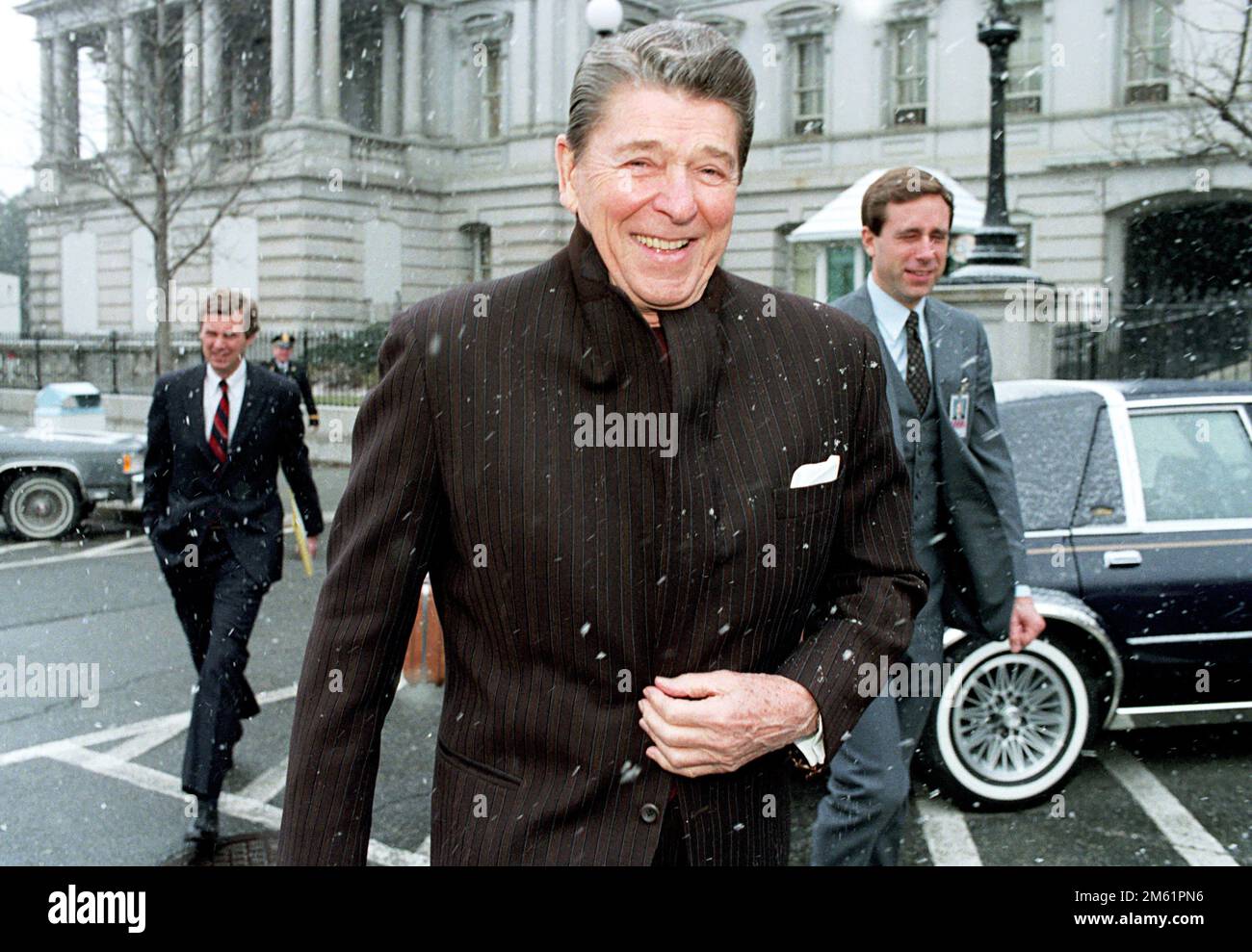 1/27/1986 President Reagan walking back to White House while it snows President Ronald Reagan Walking Back to White House While It Snows, January 27, 1986 Stock Photo