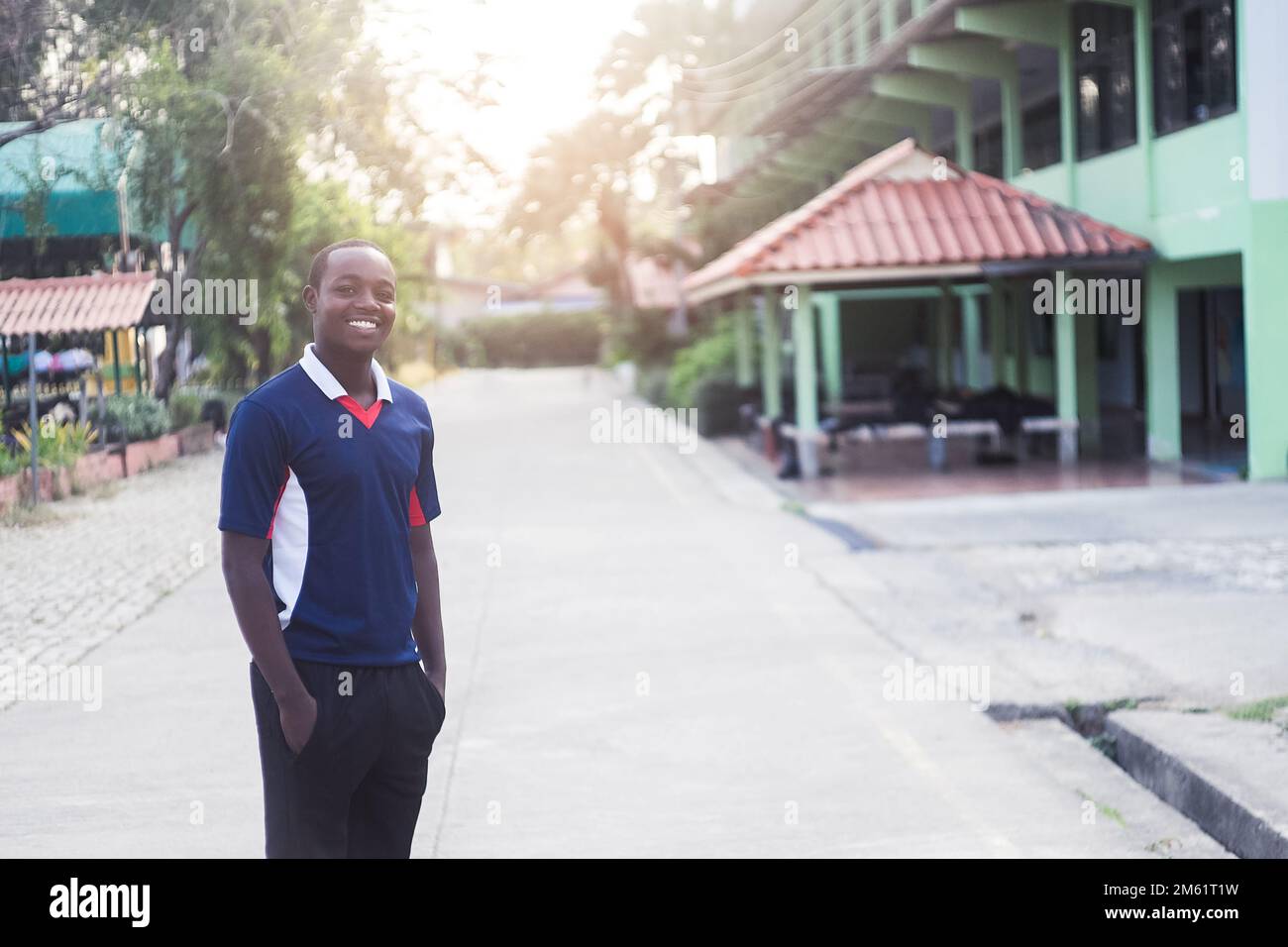 African physical education teacher in sportswear standing in school Stock Photo
