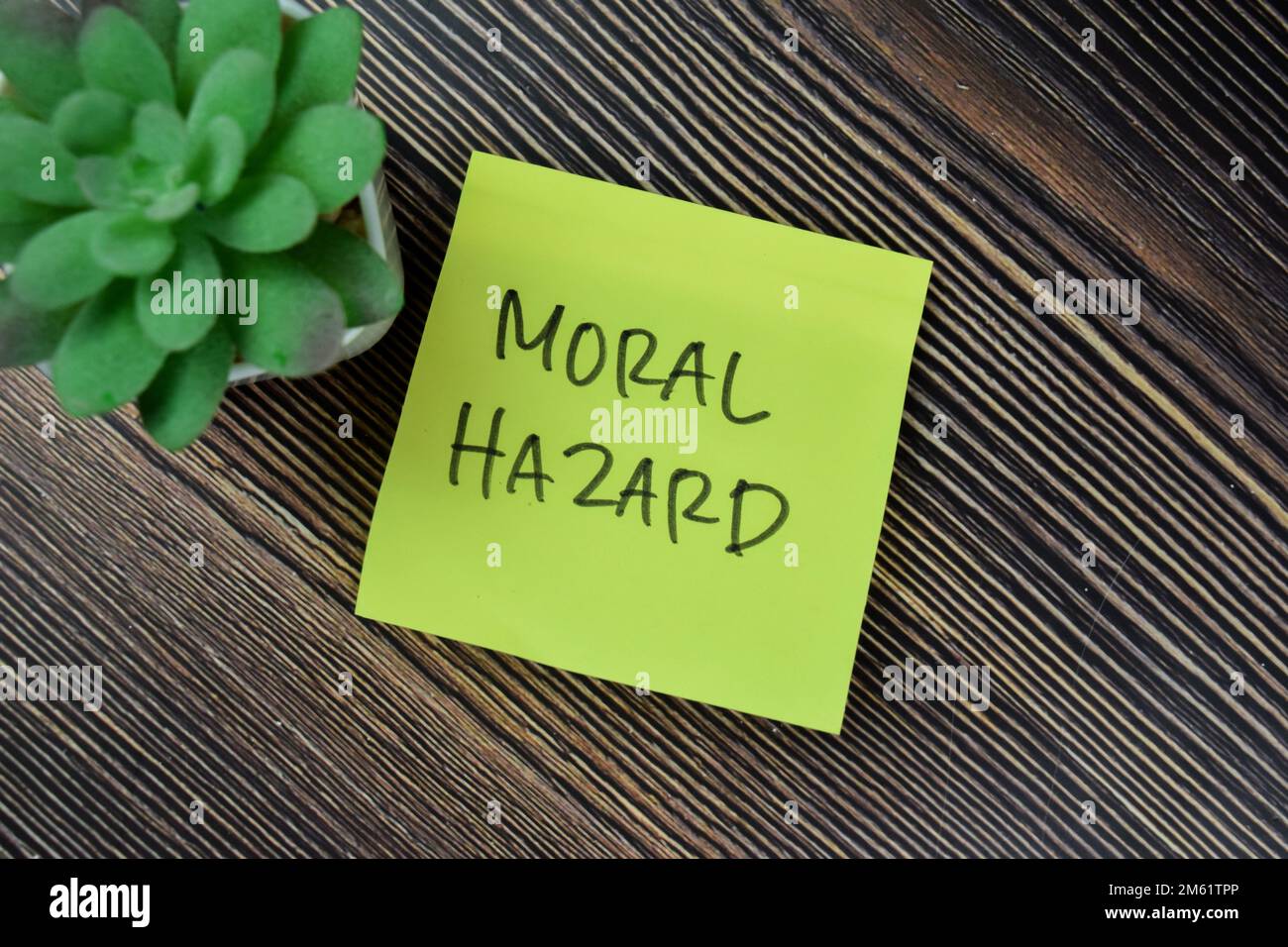 Concept of Moral Hazard write on sticky notes isolated on Wooden Table. Stock Photo