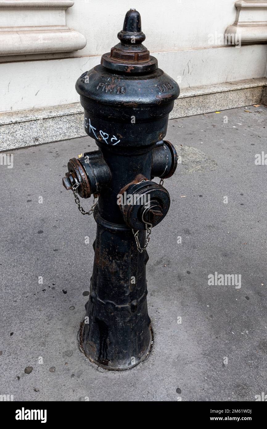 A fire hydrant on the pavement, Vienna, Austria Stock Photo