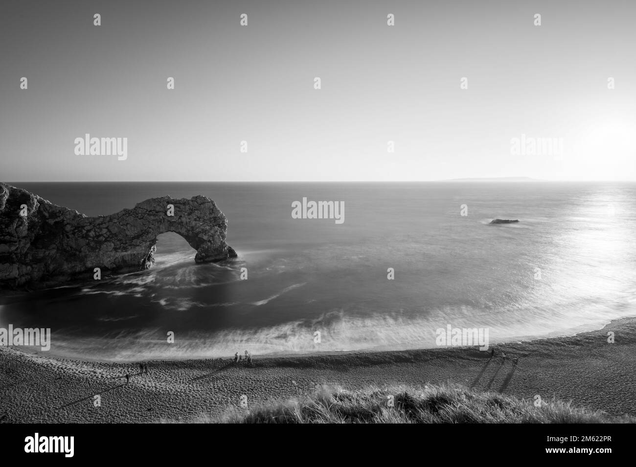 Long exposure of the calm sea at Durdle Door at dusk Stock Photo