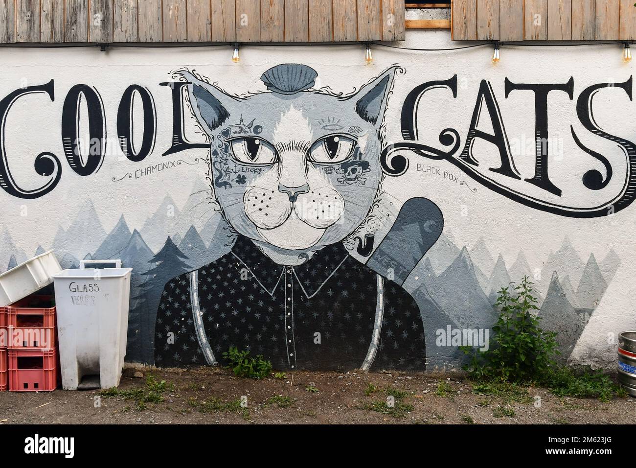 Close-up of a mural depicting a smartly dressed cat in comic style on the exterior wall of a restaurant, Chamonix-Mont-Blanc, Haute Savoie, France Stock Photo