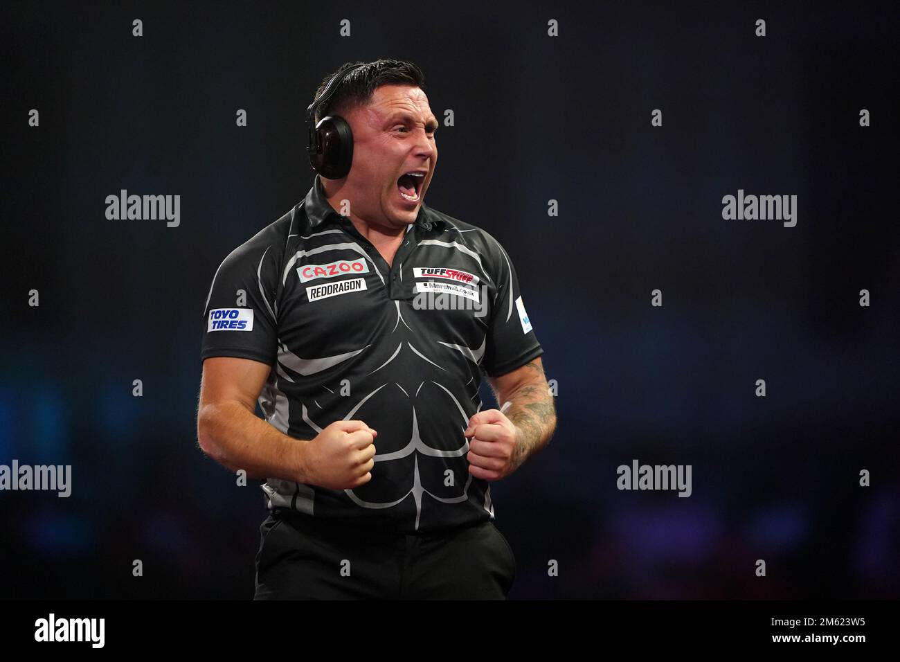 Gerwyn Price can be seen wearing ear defenders during his match against