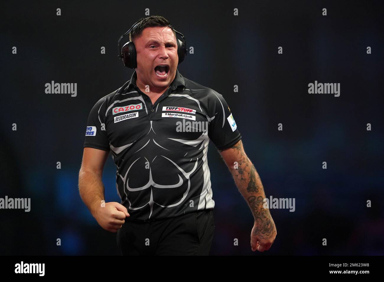 Gerwyn Price can be seen wearing ear defenders during his match against Gabriel Clemens on day