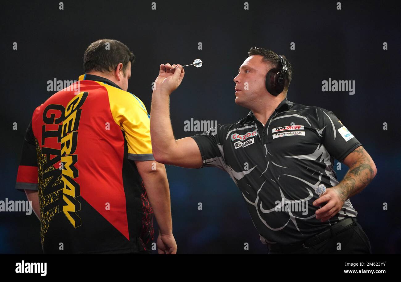 Gerwyn Price can be seen wearing ear defenders during his match against
