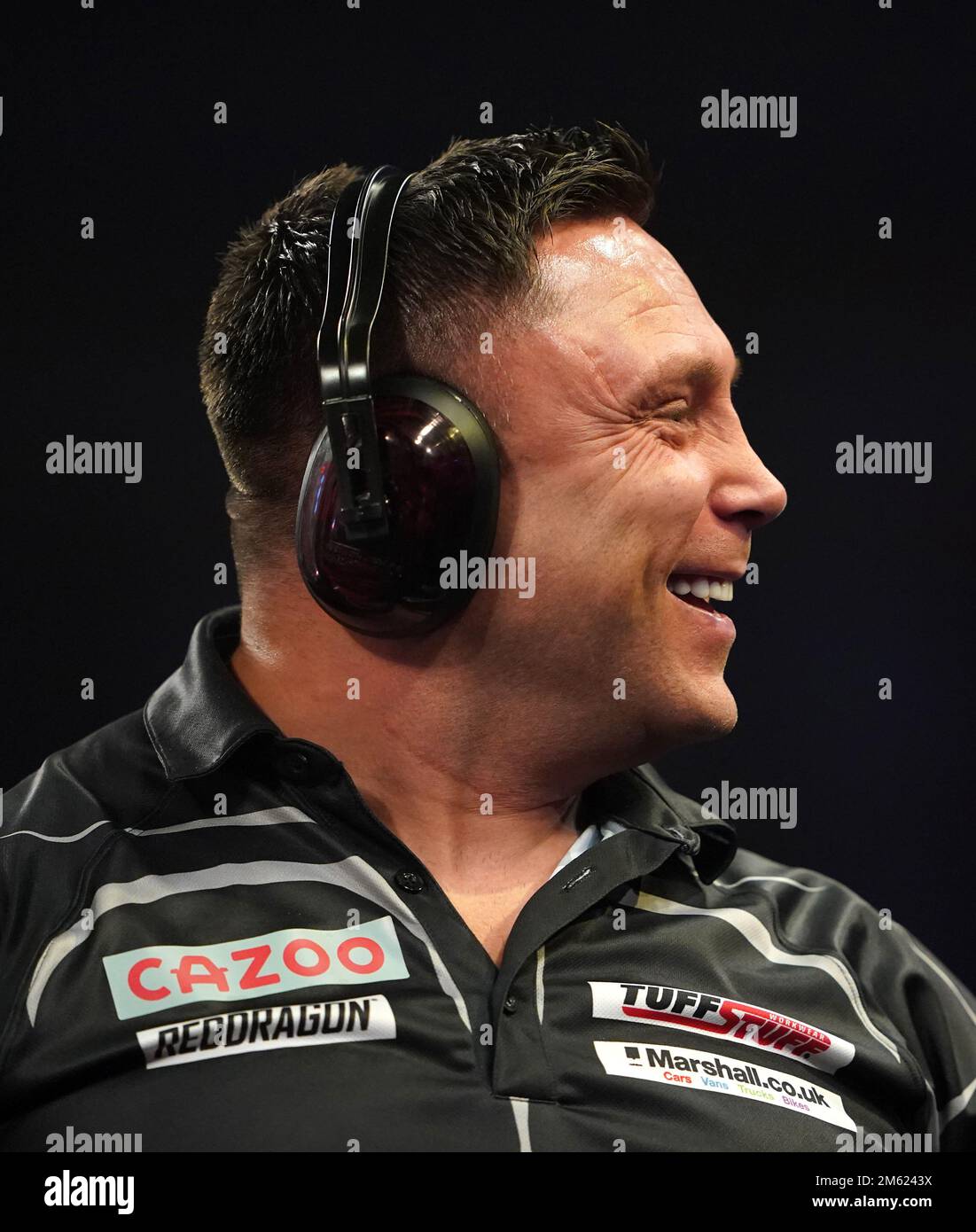 Gerwyn Price can be seen wearing ear defenders during his match against