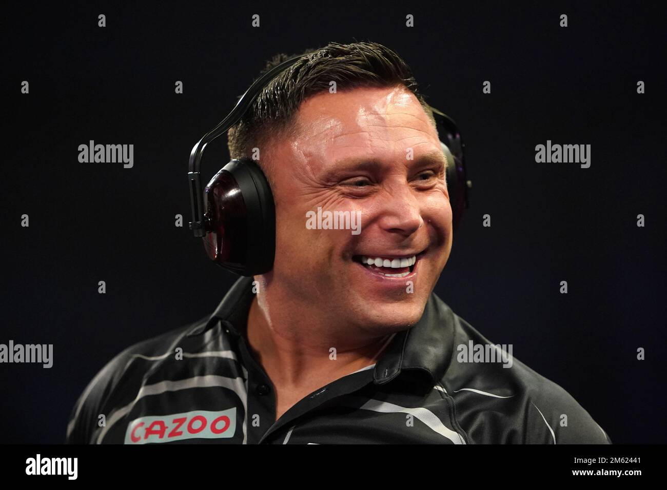 Gerwyn Price can be seen wearing ear defenders during his match against