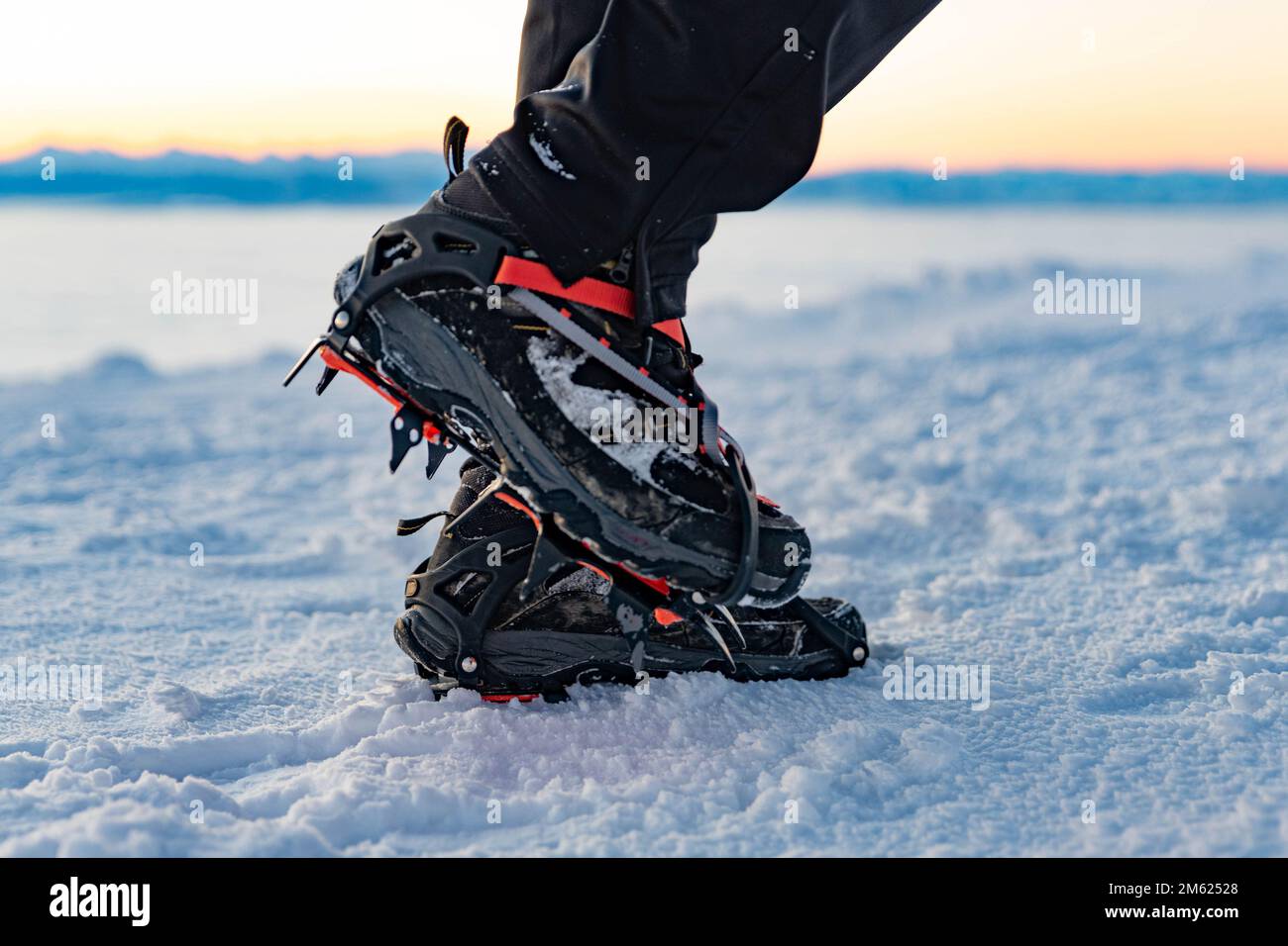 Mountain Boot with crampons on while hiking in the mountains in winter. Stock Photo