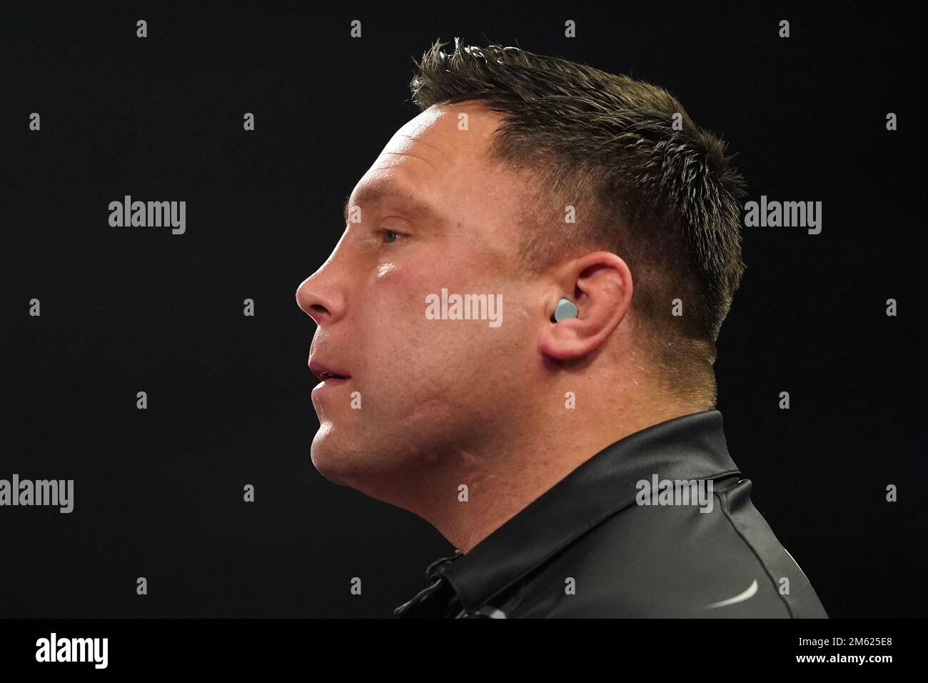 Gerwyn Price can be seen wearing ear defenders during his match against