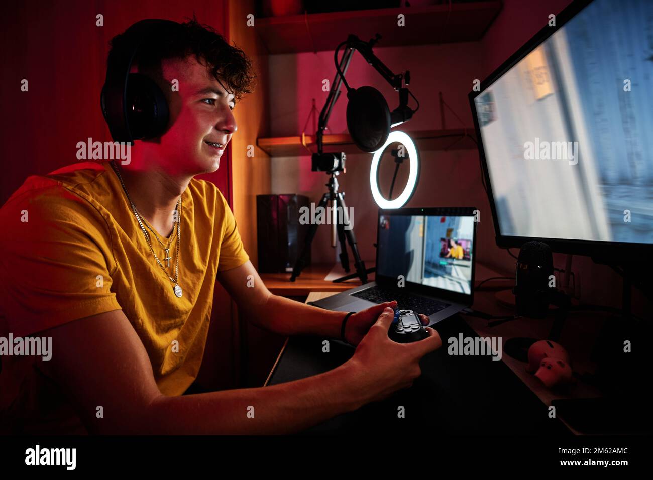 Happy gamer playing alone in a dark room Stock Photo - Alamy