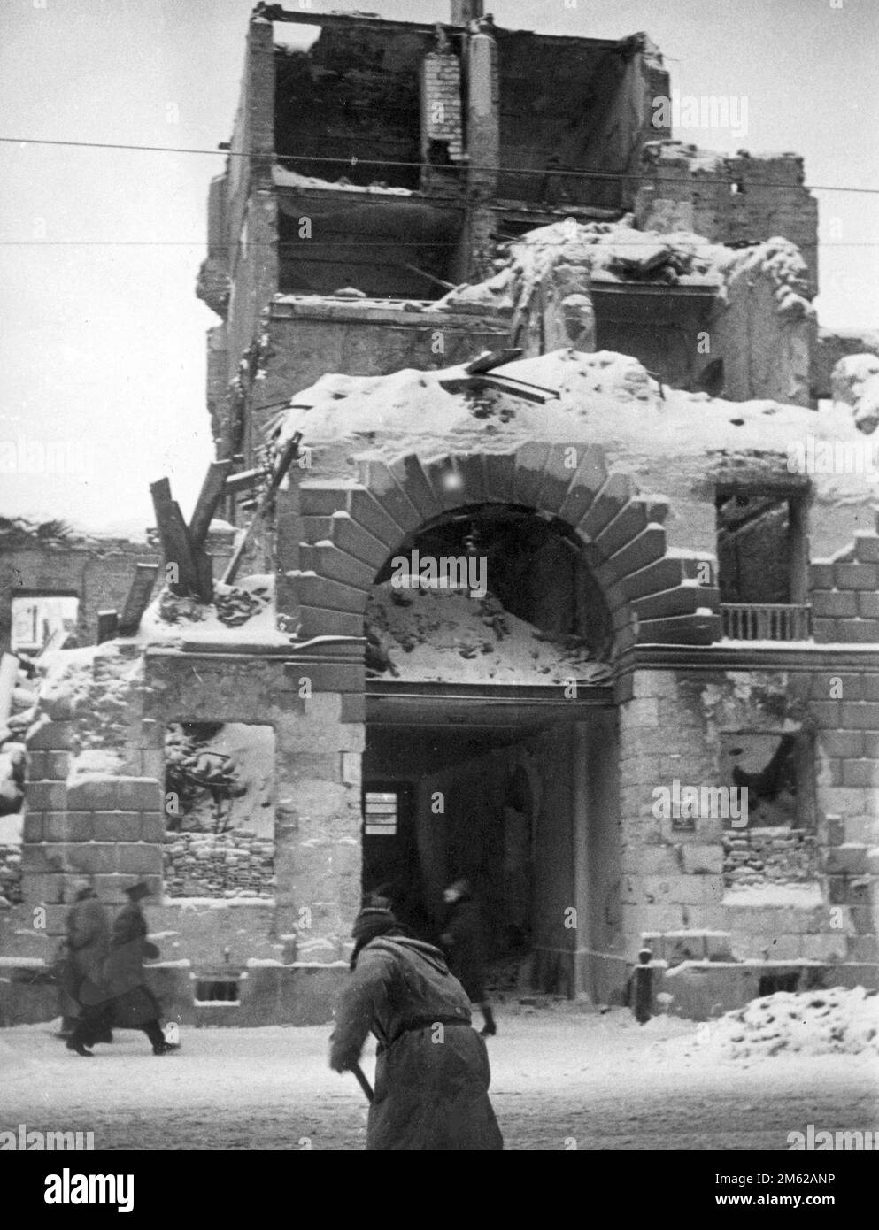 Entrance gate to a destroyed building in warsaw, Poland. The source gives the date as 1939, The people are wearing coats which suggests the image dates from late 1939 after the German invasion and Polish surrender Stock Photo