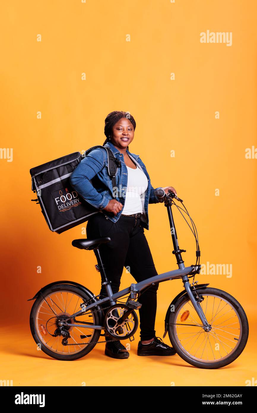 Deliverywoman holding thermal backpack ready to deliver take away