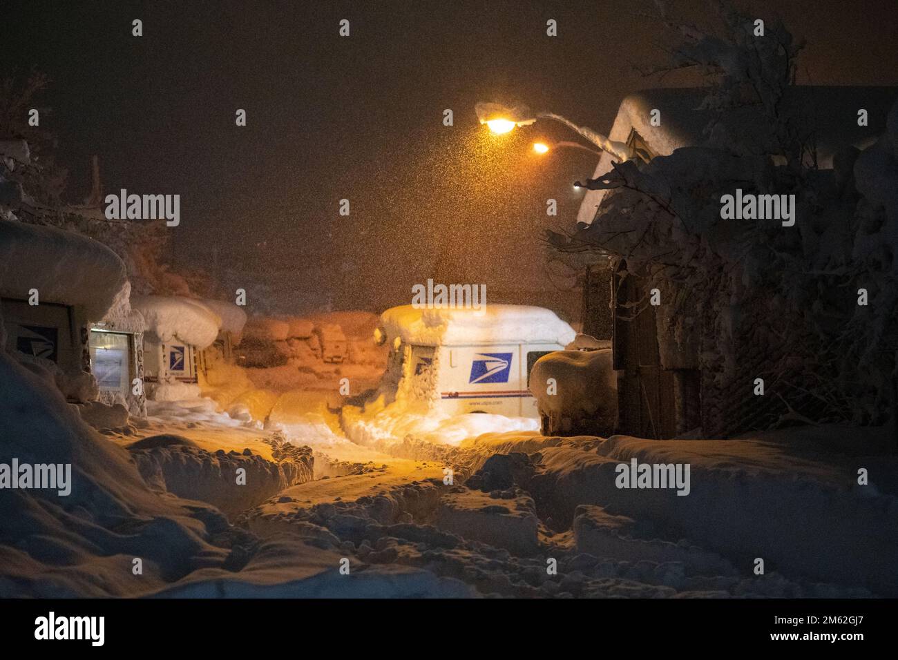 Truckee, USA. 31st Dec, 2022. USPS delivery trucks sit under a fresh