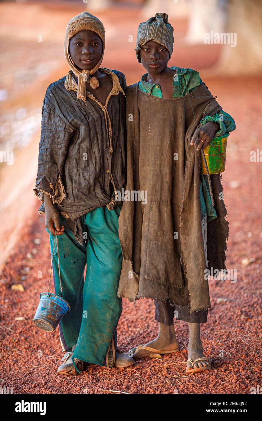 Poor children living in the backstreets of Bamako, Mali . Genuinely friendly and happy children living in extreme poverty . Stock Photo