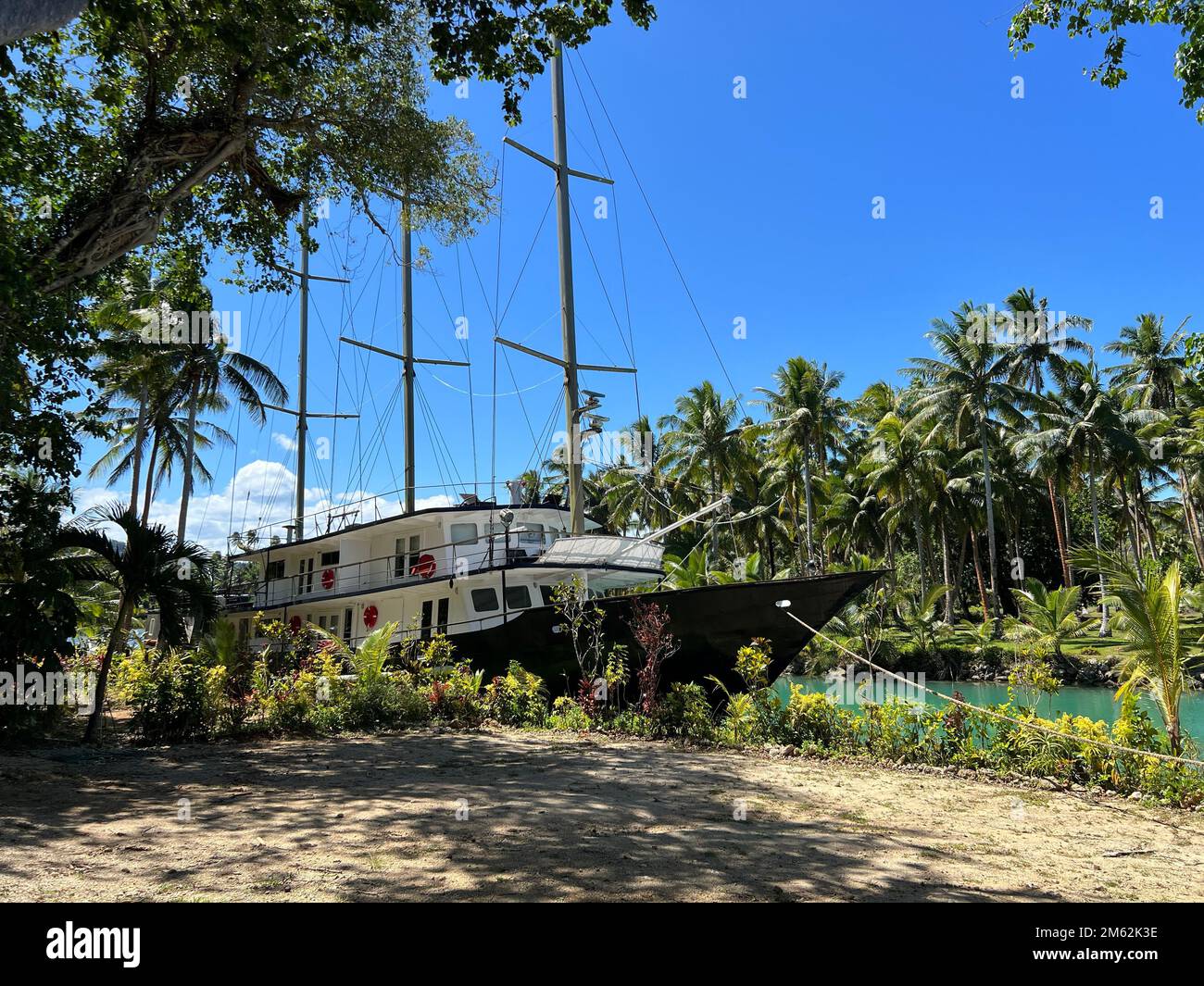 Sailing ship hidden in the jungle of a tropical island Stock Photo