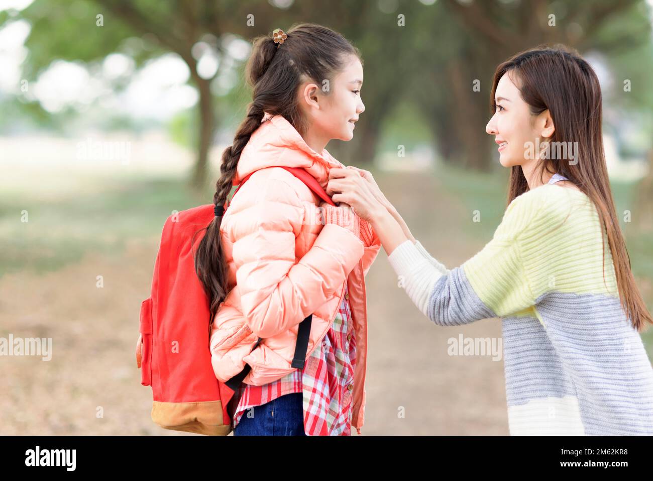 Mother comforting her daughter on the first day of school Stock Photo