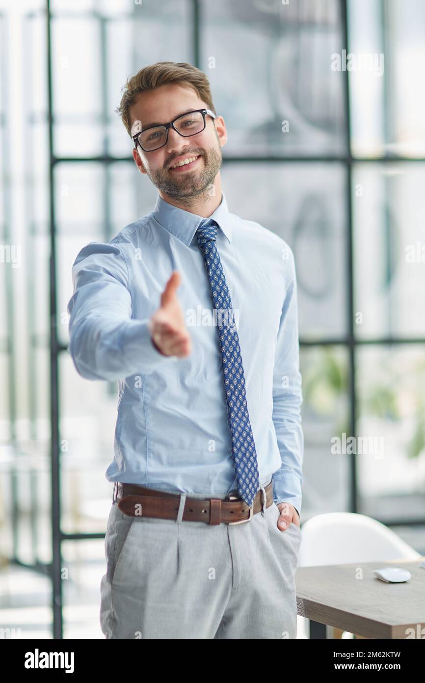 portrait confident smiling businessman offering hand for handshake Stock Photo