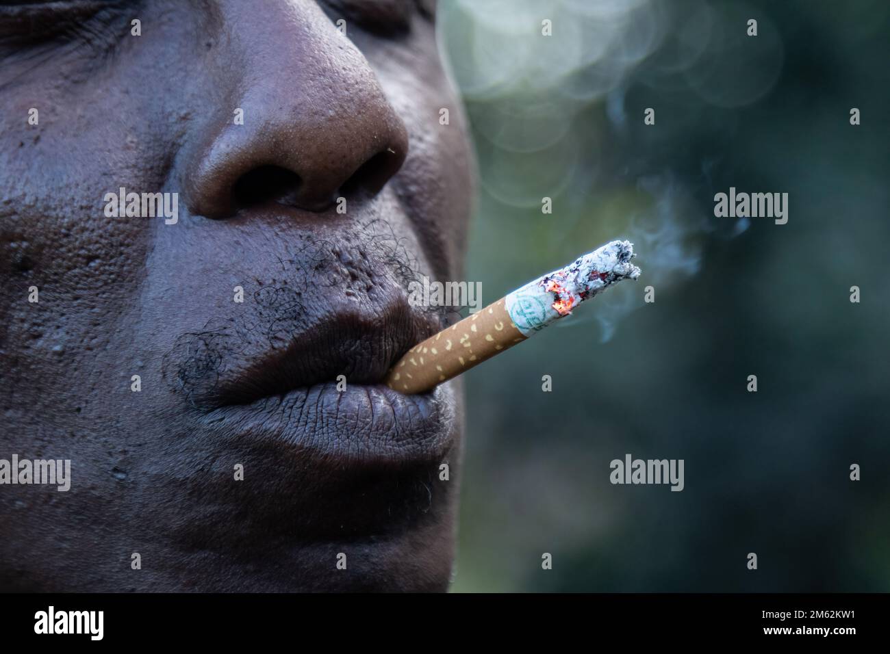 Nakuru, Kenya. 01st Jan, 2023. A man smokes a cigarette at Makao