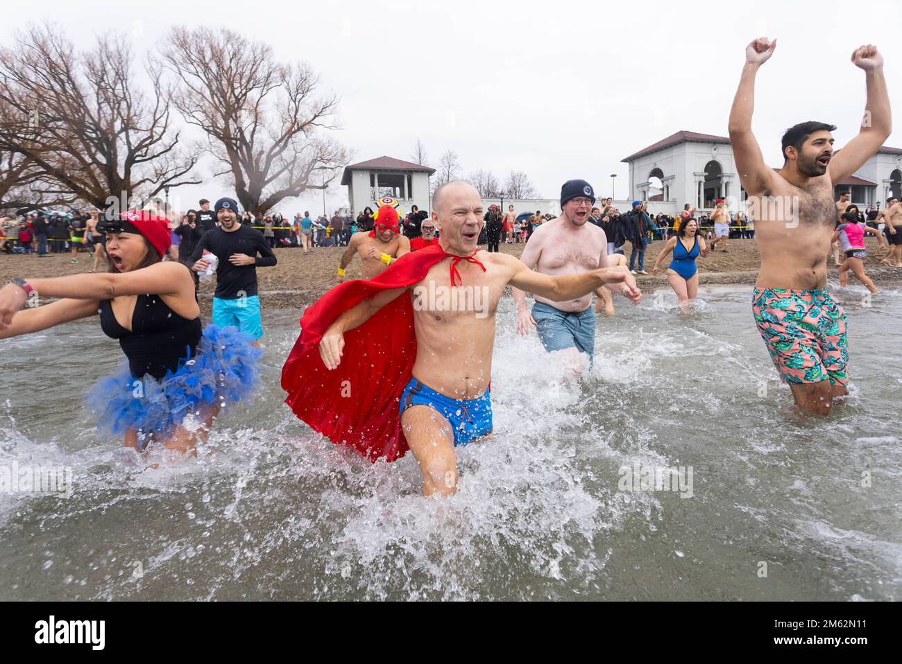 Toronto, Canada. 1st Jan, 2023. Participants run into Lake Ontario
