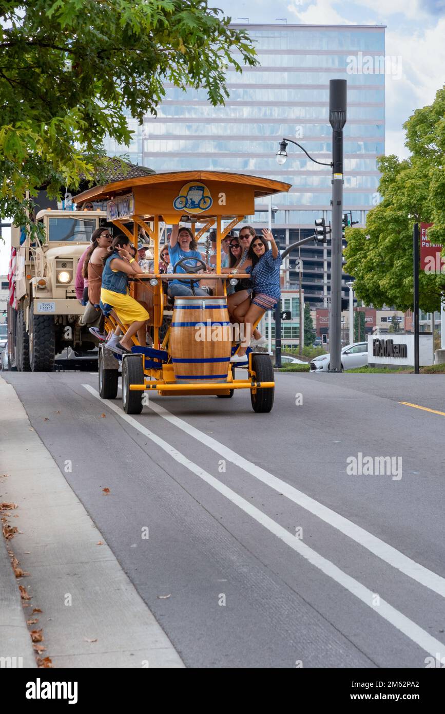 Female tourists pedal a multi-passenger human-powered bar on wheels on a fun, celebratory tour in downtown Nashville, Tennessee. Stock Photo