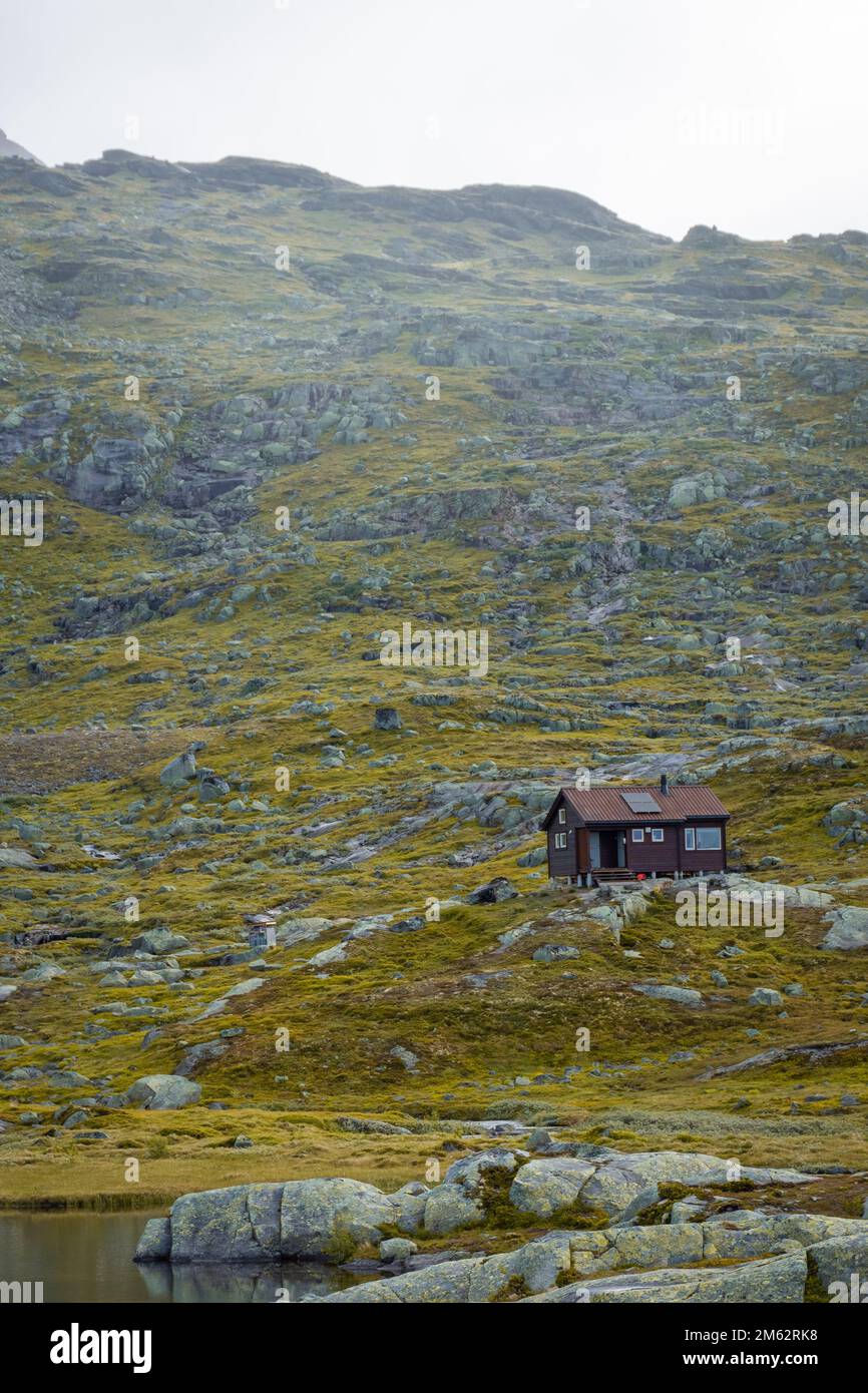 Wooden hut in the Norwegian mountains, moody landscape in the trail for