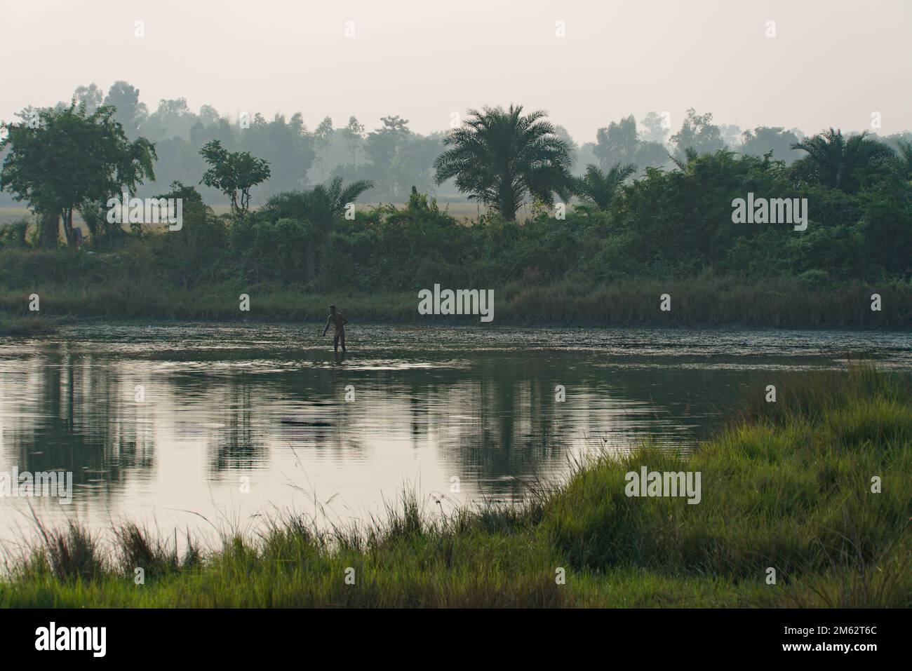 13.11.2022, West bengal, India. a lonely indian fisherman in action on a pond. Stock Photo