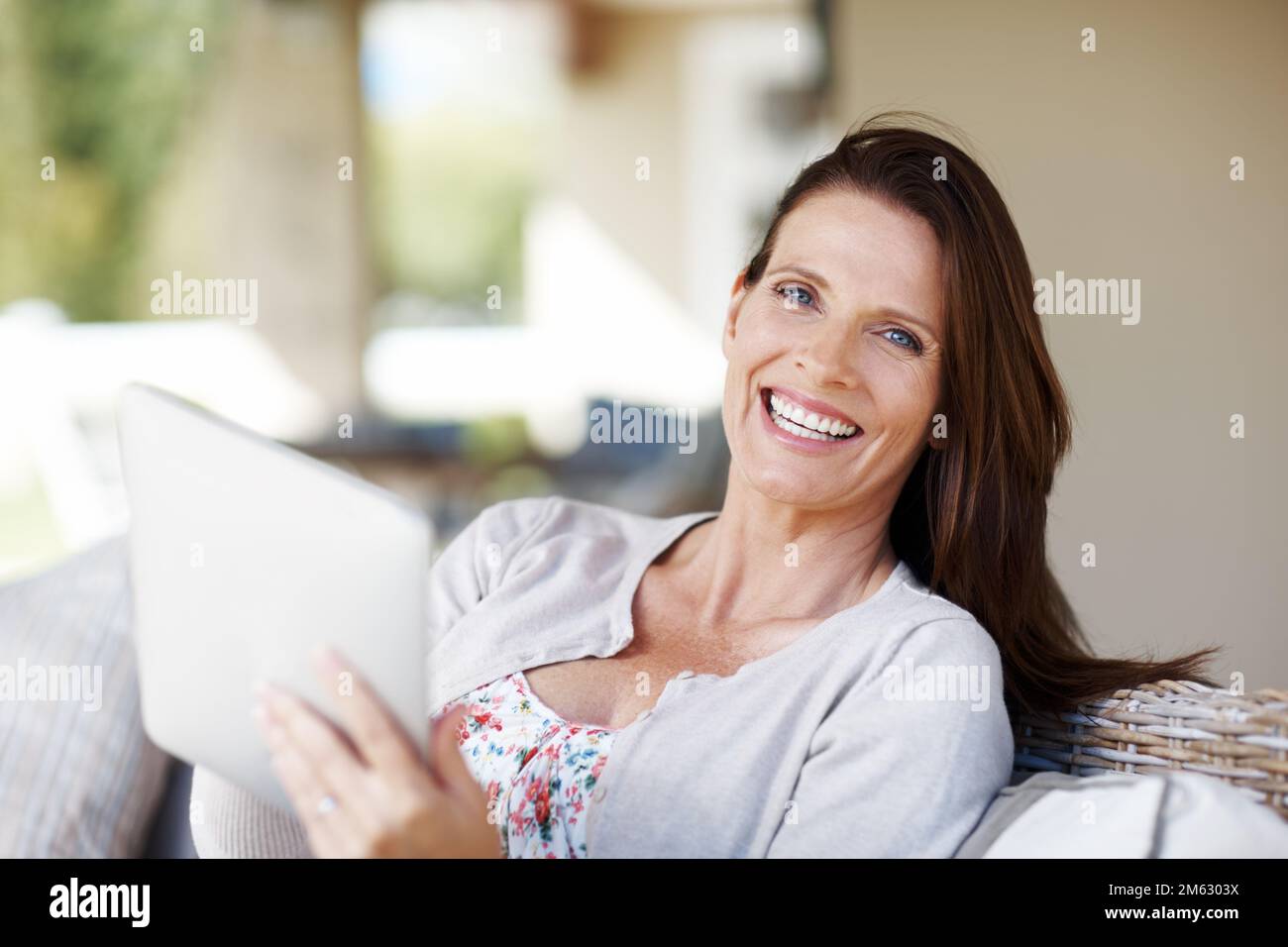 I love happy endings. Portrait of an attractive woman holding an ereader while sitting outdoors