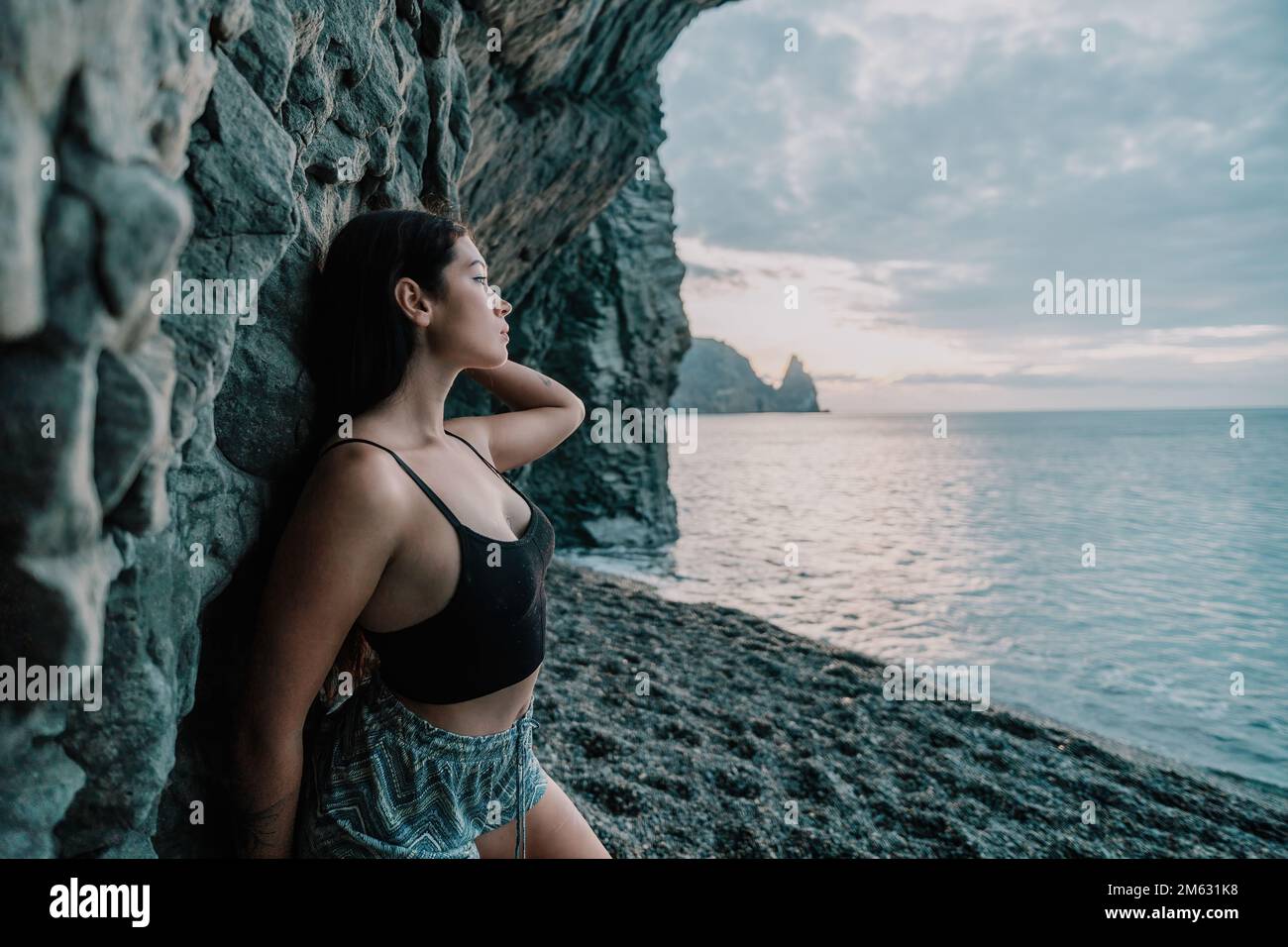 Portrait of cheerful female climber resting on a volcanic basalt Stock Photo