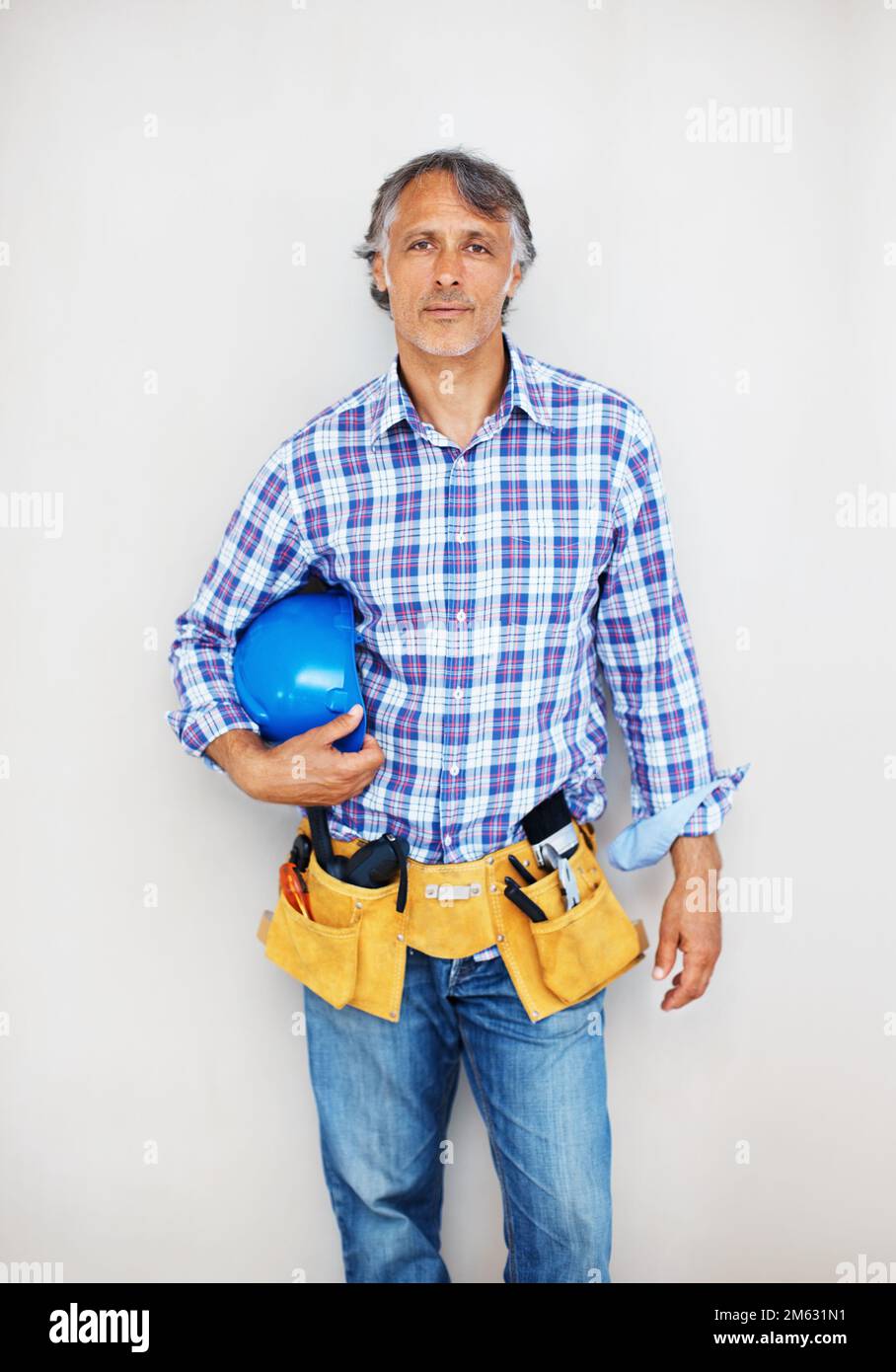 Construction worker with tool belt. Portrait of smart construction