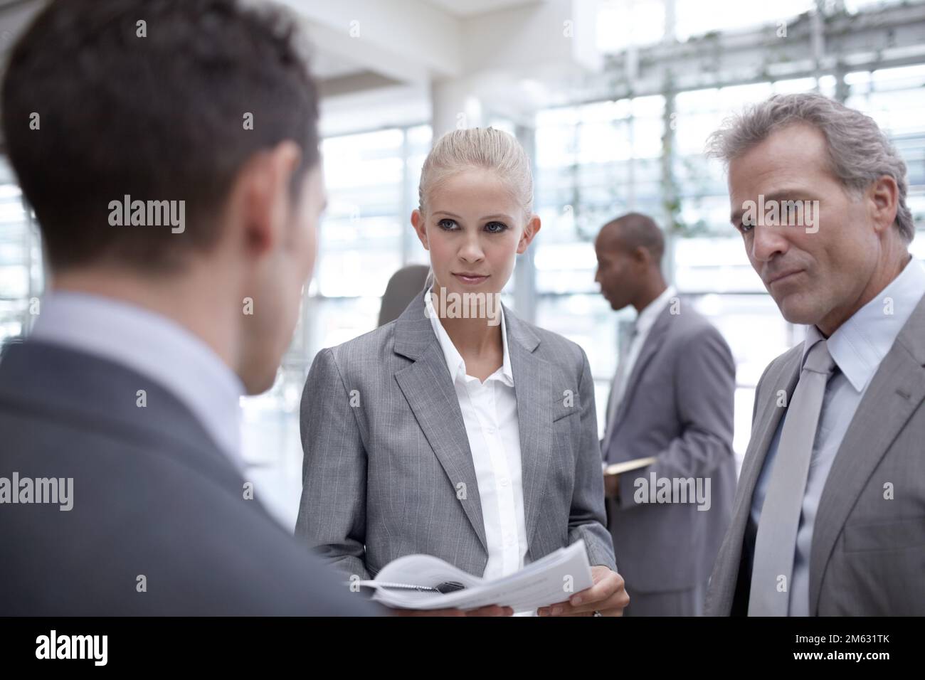 Making his point clear. A diverse group of serious-looking businesspeople looking over reports together. Stock Photo