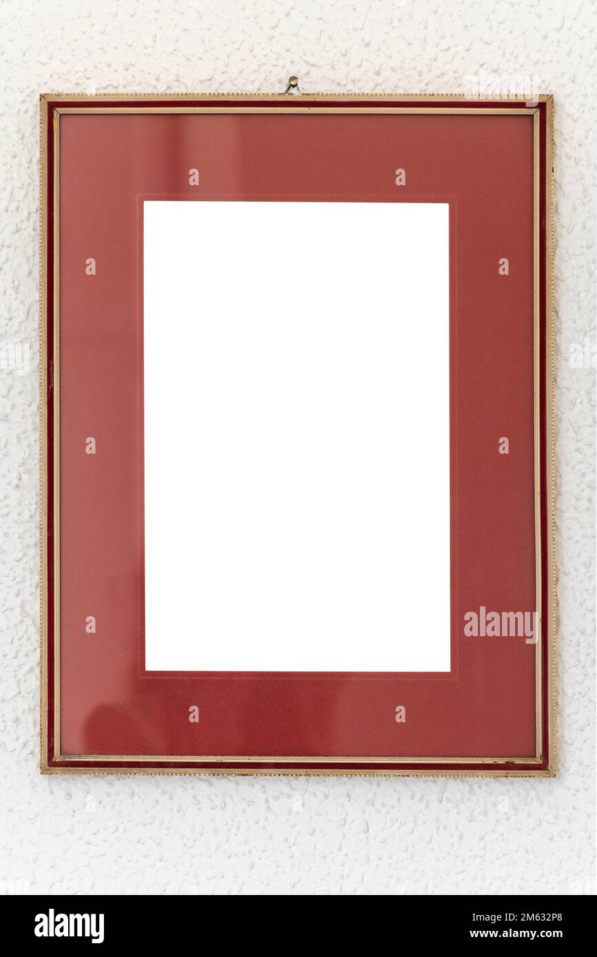 Old wooden Image frame decorated with gold on a white textured wall. Photo frame with clean copy space for your content. Stock Photo