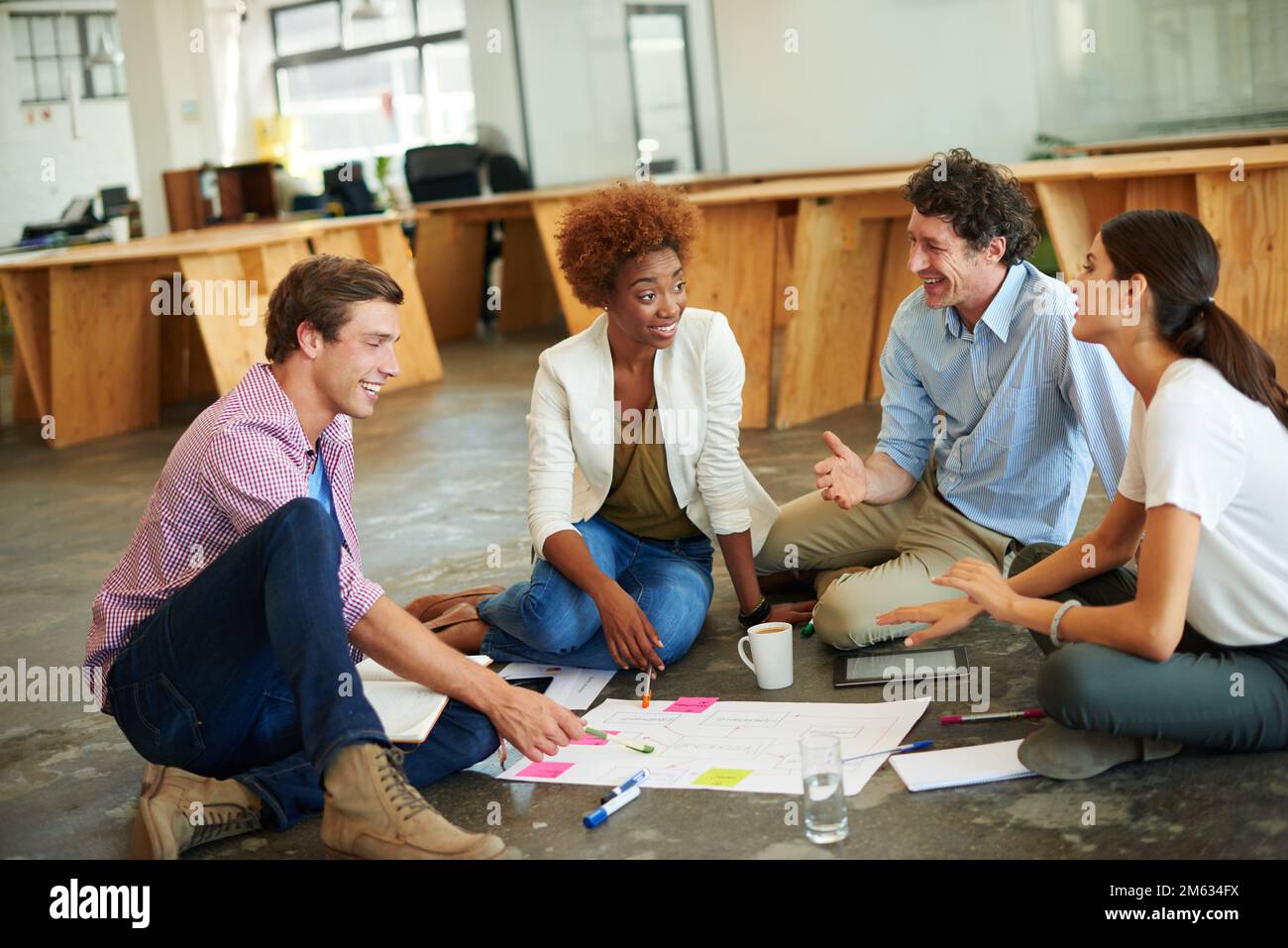 They are the best in the business. a group of designers working together on a office floor. Stock Photo
