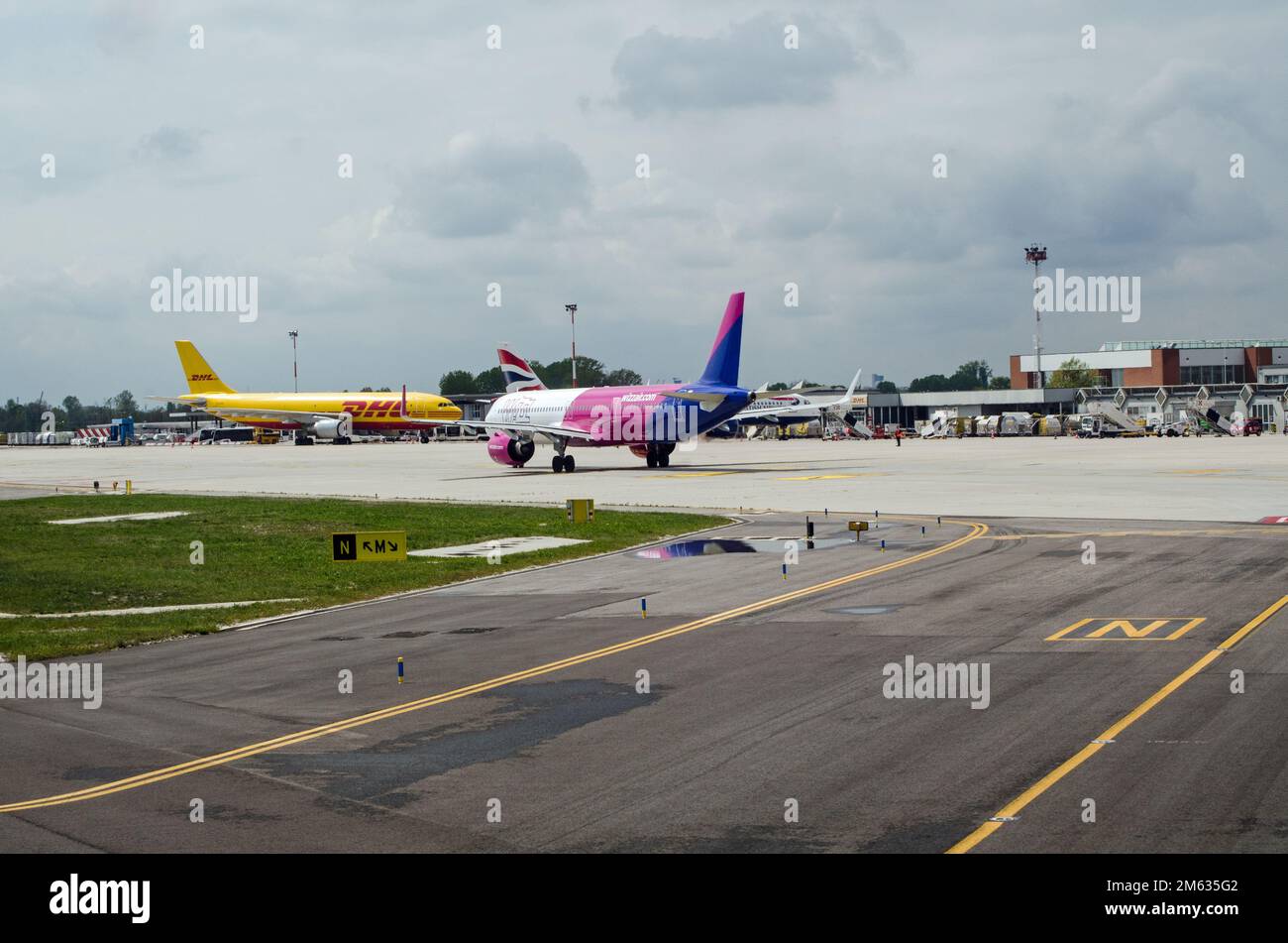 Venice, Italy - April 19, 2022:  A busy morning at Marco Polo Airport, Venice with aircraft operated by Whizz Air, DHL and British Airways. Stock Photo